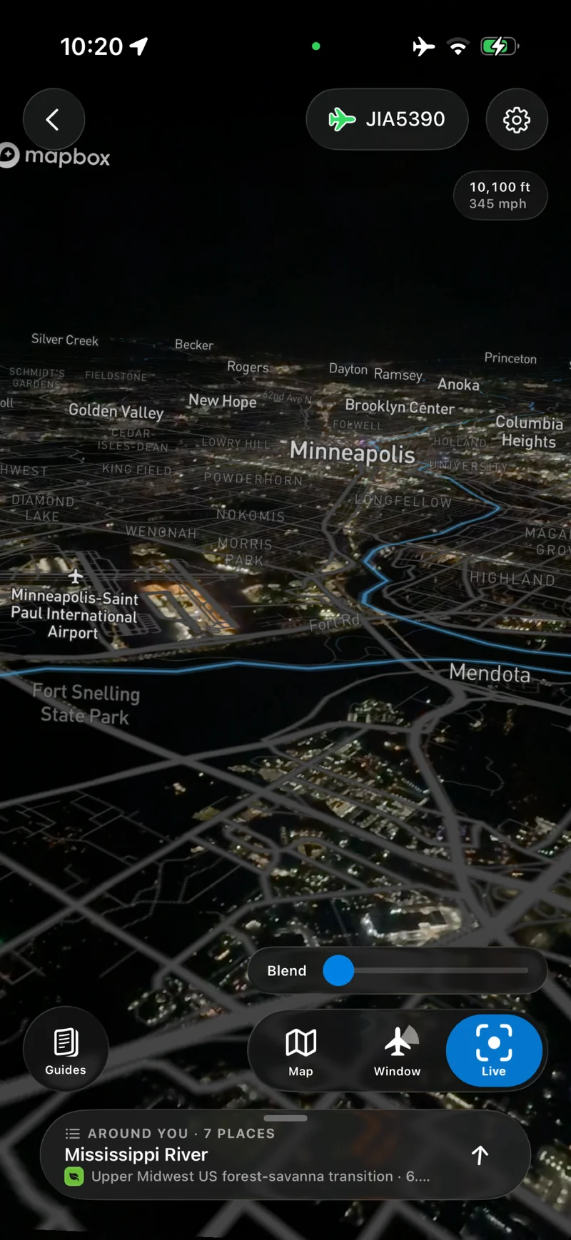 Minneapolis at night in Live view, with the Mississippi River, airport, and neighborhoods labeled and a map blend slider.